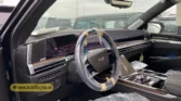 2026 Cadillac Escalade ESV driver cockpit view featuring curved infotainment display and steering wheel with protective wrap