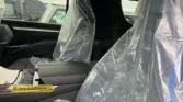 2026 Cadillac Escalade ESV second-row seating interior view with protective factory plastic wrapping