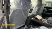 2026 Cadillac Escalade ESV front passenger seat and center console interior view with protective factory plastic wrapping