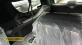 2026 Cadillac Escalade ESV third-row seating and rear cargo area view with protective factory wrapping