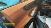 2026 Ferrari Purosangue luxury performance interior tan leather front door panel and armrest view