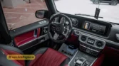 2026 Mercedes-Benz G-Class MBS Edition driver cockpit view featuring dual-screen display, custom red and black quilted leather interior, and steering wheel