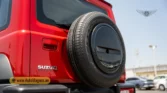 2026 Suzuki Jimny GLX AT rear quarter profile view displaying the spare wheel cover and rear pillar design