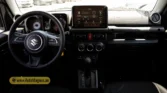 2026 Suzuki Jimny GLX AT driver cockpit interior dashboard featuring the steering wheel, touchscreen infotainment system, and climate controls