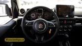 2026 Suzuki Jimny GLX AT driver side door panel trim, power window switches, and interior handle detail closeup