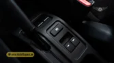 2026 Suzuki Jimny GLX AT rear center console cupholders and power window switches detail closeup